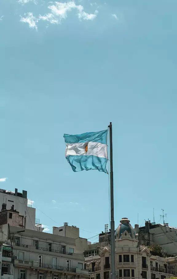 Close-up da bandeira da Argentina tremulando ao vento, símbolo nacional que você pode conhecer em sua viagem para Buenos Aires. Ideal para pacotes de viagens culturais